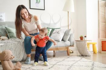 Happy mother with adorable baby boy at home�