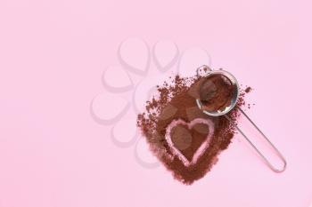 Composition with cocoa powder and sieve on color background�