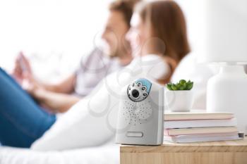 Modern baby monitor on table in parents' room�