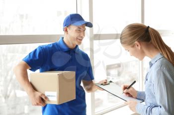 Woman signing documents to confirm receiving of order from delivery company�