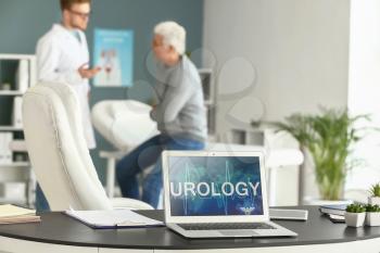 Laptop with word UROLOGY on screen in doctor's office�