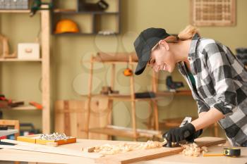 Female carpenter working in shop�