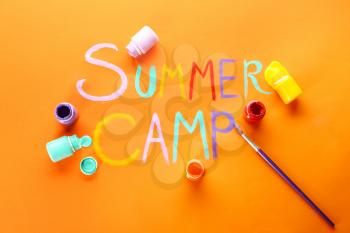Words SUMMER CAMP, paints and brush on color background�