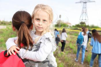 Mother with little daughter among group of illegal migrants escaping from their country�