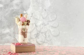 Glass with delicious freak shake on grunge background�