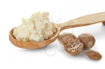 Spoon with shea butter on white background�