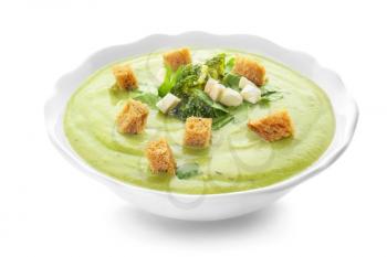 Bowl of tasty broccoli cream soup on white background�