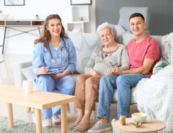 Caregiver visiting senior woman at home�