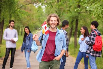 Young student with Canadian flag outdoors�