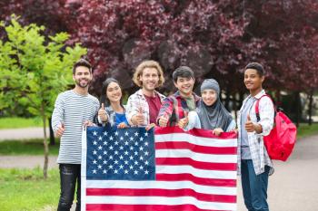 Group of students with USA flag outdoors�