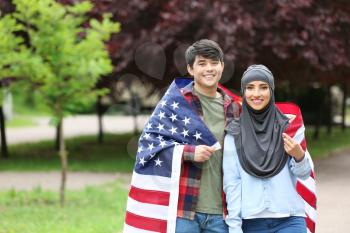 Young students with USA flag outdoors�