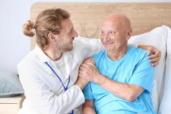 Doctor with elderly man in nursing home�