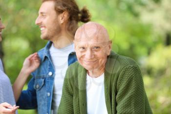 Elderly man with relatives in park�