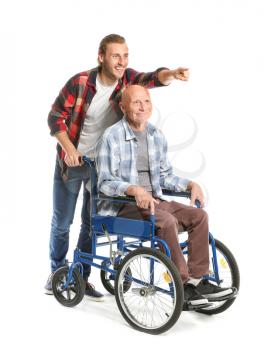 Handicapped elderly man with son on white background�