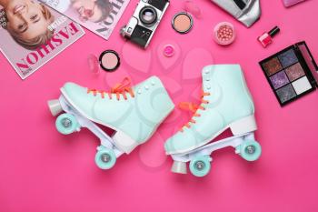 Composition with vintage roller skates, cosmetics and accessories on color background�