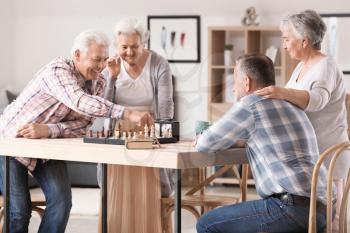 Elderly people playing chess in nursing home�