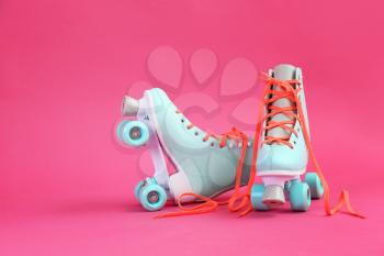 Vintage roller skates on color background�