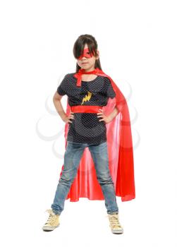 Cute little girl dressed as superhero on white background�