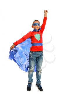 Cute African-American boy dressed as superhero on white background�