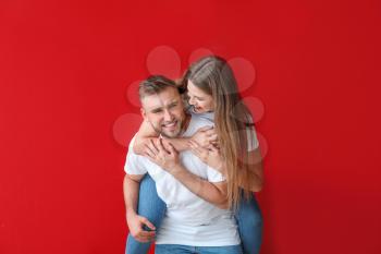 Portrait of happy young couple on color background�