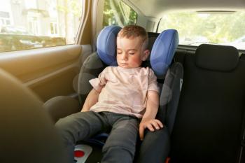 Baby boy sleeping on car safety seat�
