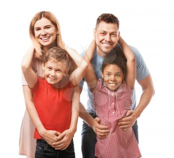 Happy couple with little adopted children on white background�