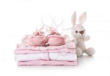 Stack of baby clothes on white background�