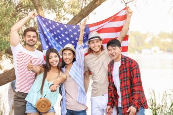 Young people with USA flag outdoors. Independence Day celebration�