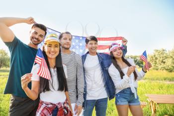 Young people with USA flags outdoors. Independence Day celebration�