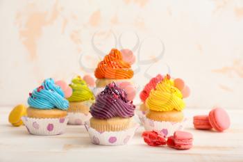 Sweet tasty cupcakes on light table�