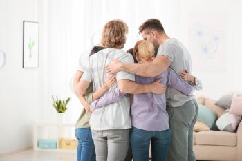 People hugging at group therapy session�