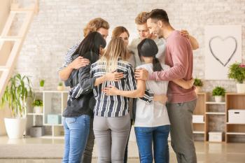 People hugging at group therapy session�