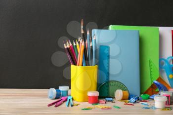 Set of school supplies on table in classroom�