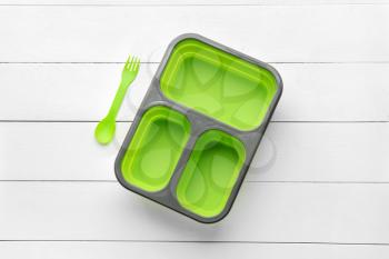 Plastic lunch box on white wooden background�