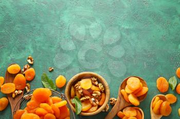 Composition with dried apricots on color background�