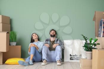 Young couple with cardboard boxes after moving into new house�