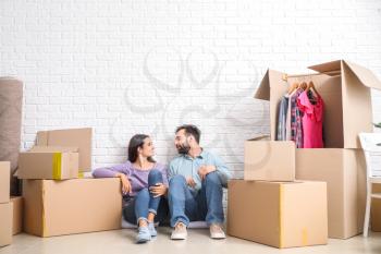 Young couple with belongings after moving into new house�