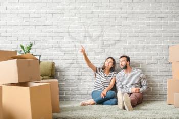 Young couple with belongings after moving into new house�