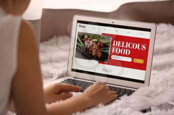 Woman with laptop ordering food online�