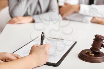 Lawyer signing document in office. Concept of divorce�