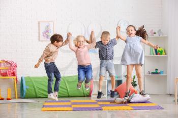 Jumping little children in kindergarten�
