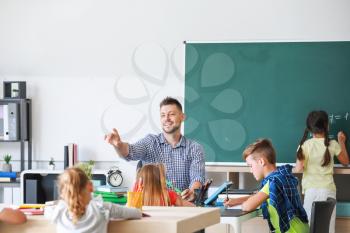 Teacher conducting lesson in classroom�
