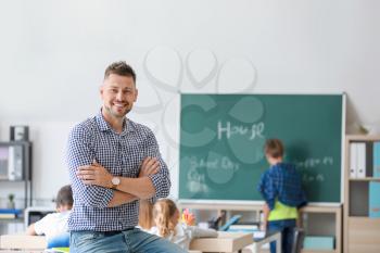 Portrait of male teacher in classroom�