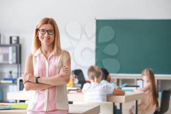 Portrait of female teacher in classroom�