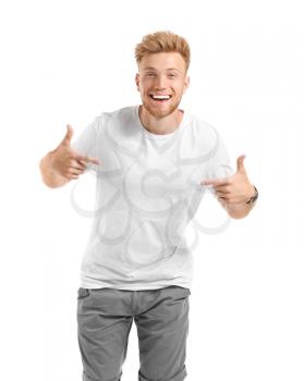 Man pointing at his t-shirt against white background�