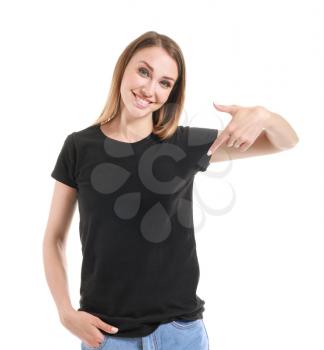 Woman pointing at her t-shirt against white background�