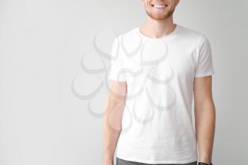 Man in stylish t-shirt on light background�
