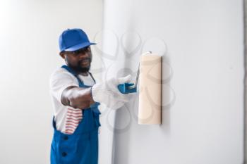 African-American decorator painting wall�