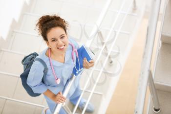 Young African-American student on stairs in clinic�