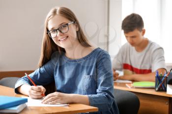 Teenage girl passing school test in classroom�